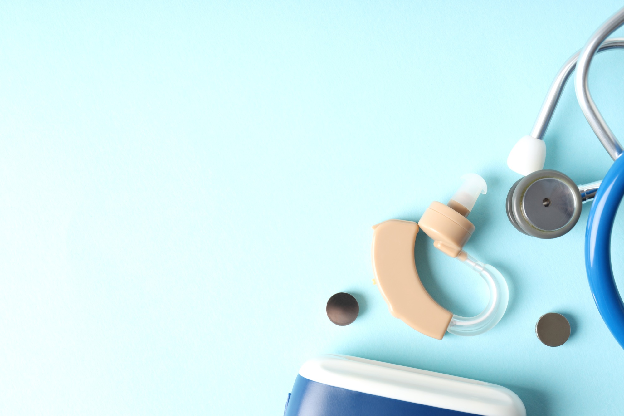 Concept of health care with hearing aid on blue background